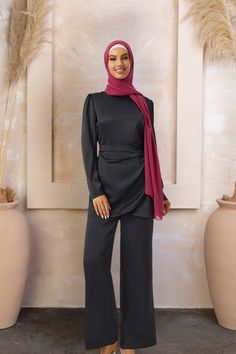 The Black Side Wrap Tunic & Pant Set is perfect for any modest wardrobe! You will love the modern meets classic with this stylish outfit! The loose fit and thigh high tunic ensure a modest fit. Made with quality, lightweight satin fabric this set is both comfortable and flattering. Two-piece Side Wrap Back Zipper High neckline Premium fabric with a slight stretch Model is 5'10" and wearing a size S Wrap Tunic, Modest Wardrobe, Modest Fits, Stylish Outfit, Black Side, Off Black, Pant Set, High Neckline, Modest Outfits