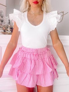 Flirtatious Gingham Ruffle Skirt Pink | Sassy Shortcake Cute Tiered Skirt Shorts With Ruffles, Cute Ruffled Mini Skirt For Summer, Cute Ruffled Summer Skirt, Cute Ruffled Skirt For Summer, Cute Summer Skirt With Ruffles, Pink Tiered Bottoms With Layered Hem, Cute Plaid Skirt For Spring, Spring Gingham Tiered Skirt, Tiered Ruffled Shorts For Spring