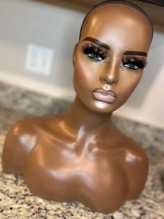 a mannequin head sitting on top of a counter