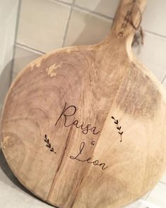 a wooden cutting board with the names of two people on it and an inscription that reads, rose & lion