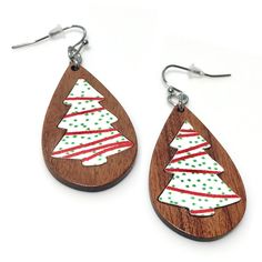 I think we all await the season for the festive snack cakes to arrive! These adorable Christmas tree earrings are nade of walnut and laser cut pattern, the inlay is set into the wood. Earring hooks are made of surgical stainless steel so they will not tarnish over time promoting long wear and safe for sensitive skin types.  Earrings are a tear drop shape that dangle about 2 inches long. Comes with rubber ear-nut backings.  Makes a perfect gift idea for Secret Santa, Yankee swaps, stocking stuffe Christmas Earrings Wood, Wood Christmas Earrings, Wooden Christmas Earrings, Engraver Projects, Wood Teardrop Earrings, Bee Ideas, Glowforge Ideas, Snack Cakes, Diy Stocking Stuffers