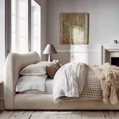 a bed with pillows and blankets in a room