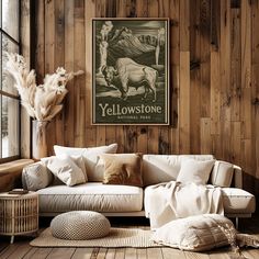 a living room with wood paneling and a white couch in front of a window