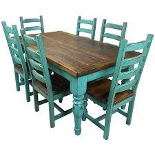 a wooden table and six chairs with blue paint on the top, in front of a white background