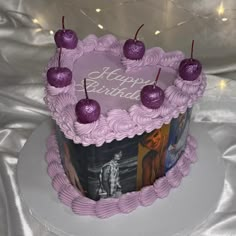 a birthday cake with pink frosting and cherries on top