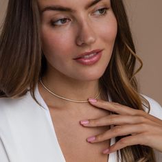 Give the gift of sparkle this holiday season with our Diamond Tennis Choker Necklace. Featuring dazzling diamond gemstones on a delicate chain, this versatile piece adds elegance to any look—from casual outings to glamorous date nights. A perfect Christmas gift to make someone shine. SKU: RR-NR152 Product Details Finish/Material: 18K Gold Over Brass ∙ Rhodium Over Brass, CZ Diamond Gemstones Featuring a Dainty ~2mm CZ Diamond Tennis Choker Necklace, available in 2 lengths: 14 Inches + 2 Inch Ext Caitlyn Minimalist, Tennis Choker Necklace, Sideways Initial Necklace, Dainty Diamond Necklace, Diamond Huggies, On Date, Art Deco Diamond Rings, Silver Pearl Necklace, Valentines Necklace