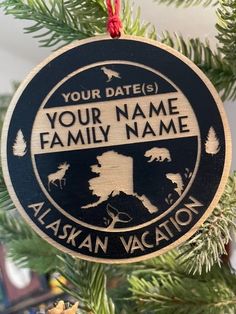 an ornament hanging from a christmas tree with the words your name, alaska vacation on it