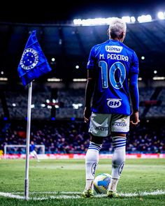 a soccer player is standing on the field