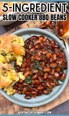 a bowl filled with baked beans next to bread