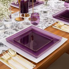 the table is set with purple plates and gold cutlery, along with silverware