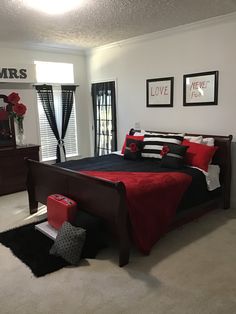 a bed room with a neatly made bed and pictures on the wall