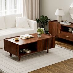 a living room filled with furniture and a large mirror on the wall above it's coffee table