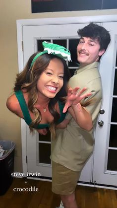 a man and woman posing for a photo in front of a door with the words crocodile on