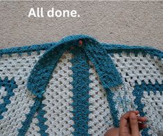 someone is crocheting on the floor with a blue and white blanket that says, all done