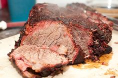 a piece of meat sitting on top of a cutting board