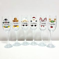 five wine glasses with different designs on them