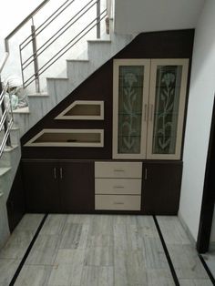 an empty room with stairs leading up to the second floor and glass doors on the wall