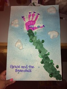 a child's hand holding up a piece of paper that says grace and the beanshak