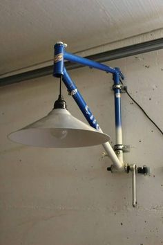 a blue and white lamp hanging from the side of a wall