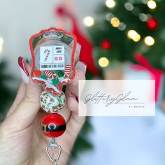 a woman holding a christmas ornament in her hand