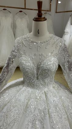 a white wedding dress on display in a store