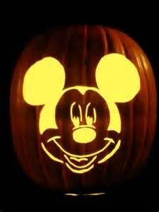 a mickey mouse pumpkin carved into the shape of a face