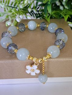 Elastic bracelet handmade with 12 mm aquamarine semiprecious stones, blue crystals and enamelled brass flower pendant. Length 17 cm. Square Beads Jewelry Ideas, Handmade Bracelets Tutorial, Girly Bracelets, Crystal Anklet, Wrist Jewelry, Trendy Bracelets, Gems Bracelet, Beaded Wrap Bracelets