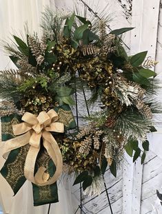 This stunning green and gold Christmas wreath will be a magnificent addition to your festive decor, sure to impress all your visitors. It showcases emerald green hydrangeas, verdant pines, elongated flocked pine picks, and golden ferns, all arranged on a natural 16-inch grapevine base. Adorned with emerald green hydrangeas tied with green and gold designer ribbon bows, this wreath is further enhanced with gold ferns, gold leaf picks, an assortment of gold and green leaf picks, and shimmering golden balls. The dimensions of the wreath are 29x26x3 inches. To ensure its longevity, it is advised to hang the wreath in a well-protected area, safe from the elements. Thanks In advance for your purchase. I would appreciate it if you favorited my Etsy shop, so you'll be notified when new items are a Christmas Wreath Designs, Green And Gold Christmas, Gold Christmas Wreath, Wreath Hydrangea, Gold Wreath, Green Hydrangea, Hydrangea Wreath, Seasonal Wreaths, Gold And Green