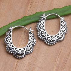 Designed with inverted arches, Made Suyana's silver earrings are a pretty twist on the classic hoop. The Balinese artisan uses sterling silver to hand craft the earrings, engraving the precious metal with openwork hearts and an adorable dot motif. Artisan Handmade Silver Hoop Earrings, Artisan Sterling Silver Hoop Earrings, Traditional Sterling Silver Hoop Earrings With Ear Wire, Sterling Silver Hoop Jewelry With Intricate Design, Traditional Handmade Hoop Earrings For Anniversary, Metal Fab, Engraved Earrings, Earrings Ideas, Silver Earrings Handmade