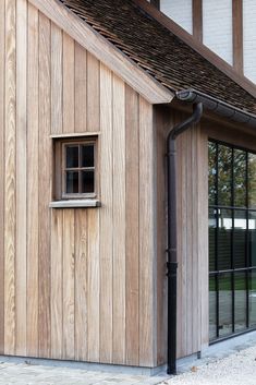 the side of a wooden building with a window