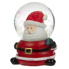 a snow globe with a santa claus in it's lap and his hat on