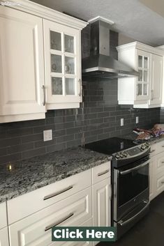 a kitchen with white cabinets and black granite counter tops is pictured in this image, there are no people or objects on the counter