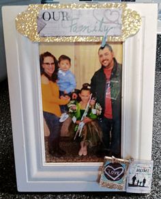 a white frame with a family picture on it