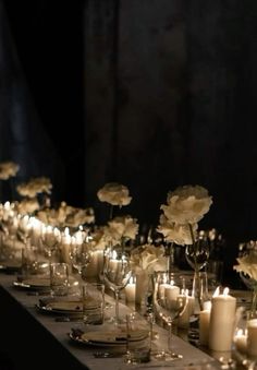 a long table with candles and flowers on it