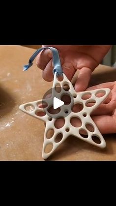 someone is making a star ornament out of clay