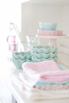 several dishes and cups on a white table