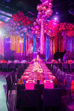 a long table with purple and pink decorations