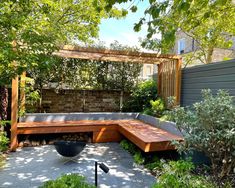 a wooden bench sitting in the middle of a garden