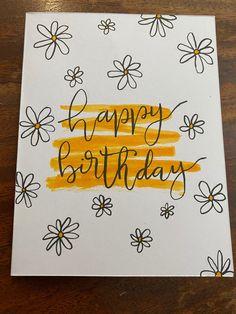 a birthday card with flowers and the words happy birthday written in black ink on white paper