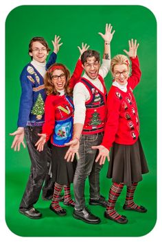 a group of people standing next to each other in front of a green background wearing ugly sweaters