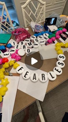 a table topped with lots of letters and balloons