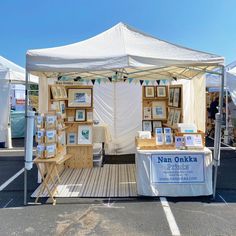 a tent with pictures on it in the middle of a parking lot