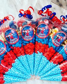 spiderman themed candy sticks and candies in cellophane bags on a marble table