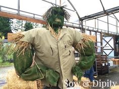 a man dressed as the hulk is standing in hay bales