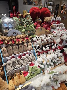 many stuffed animals are on display in a store