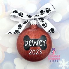 a red ornament with a dog's paw print on it