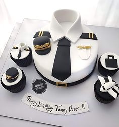 a birthday cake with cupcakes in the shape of an airplane pilot's uniform