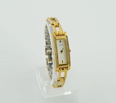 This elegant and minimalist vintage Accurist watch features a sophisticated golden hue. The timepiece boasts a rectangular case, tastefully adorned with stones along its edges, imparting a subtle yet luxurious charm. Its bracelet is composed of rectangular links, creating a seamless and classic look. The design is timeless, showcasing the enduring allure of vintage accessories. Dimensions: Bracelet Length: up to 16.3 cm (6.4 inches) - adjustable Case Width: 1.3 cm (0.5 inches) Bracelet Width: 7 mm (0.3 inches) Condition: The watch is in good vintage condition, exhibiting signs of wear with scuffs on the bracelet, which are consistent with its age and provide character. The detailed craftsmanship is evident in every aspect of its design, as seen in the accompanying photos. All presented wat Son Bracelet, Minimalist Vintage, Wrist Watches, Vintage Accessories, Gold Watch, Classic Looks, Time Piece, Womens Watches, Wrist Watch