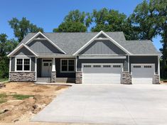 a large house with two garages in the front and one on the other side