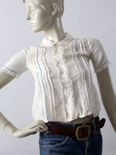 "This is a vintage silk blouse circa 1920s. The cream silk top features pin tuck pleats down the front with blue laced stitching and lace trim. It buttons closed. CONDITION In great condition. Approximate Fit: XS MEASUREMENTS Bust: 30\" ... 76.2 cm Length: 18\" ... 45.7 cm Shoulders: 12\" .. 30.5 cm Outside Sleeve: 8\" ... 20.3 cm HOW WE MEASURE * Blouse measured lying flat * Bust measured armpit to armpit * Length measured down the center of the back * Shoulders measured between the shoulder se Lace Button, Cream Silk, Button Up Top, Pin Tucks, Vintage Silk, Silk Top, Silk Blouse, Lace Trim, Fall Outfits